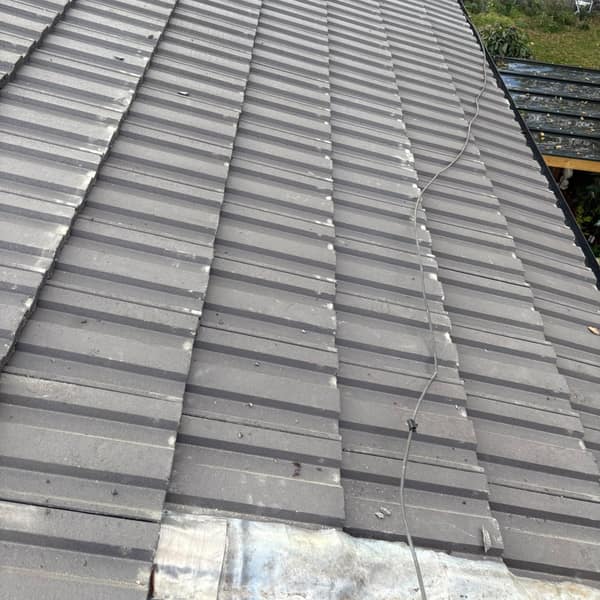 New grey roof tiles on the main slope of the bungalow