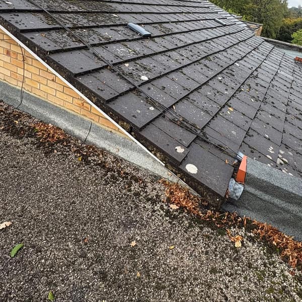 The old tiled roof and the flat roof beside it, before the job