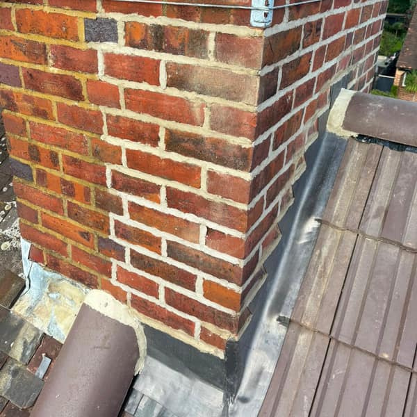 Lead flashing where the chimney stack meets the new roof tiles