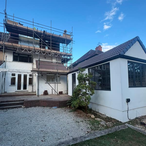 Back of the house with scaffolding up, and the garden building with its new roof, Watford
