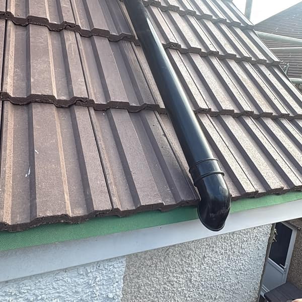 Downpipe running over the new roof tiles