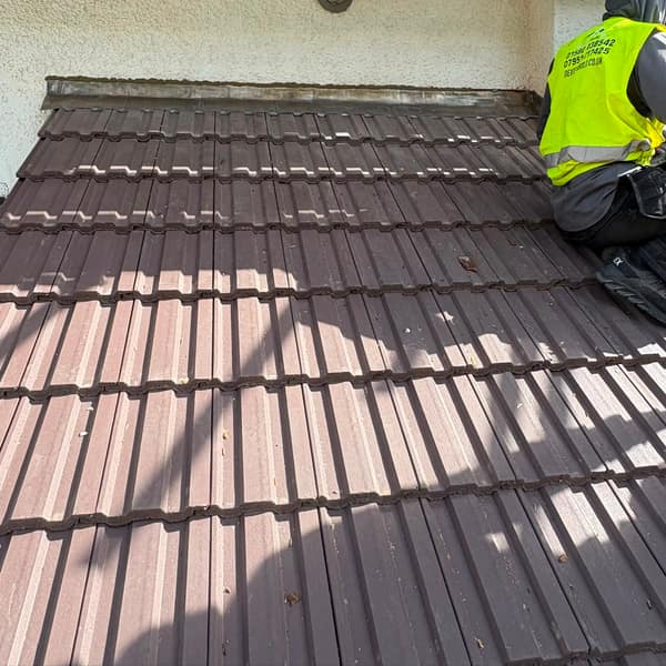 Tiling the lean-to roof at the back of the house