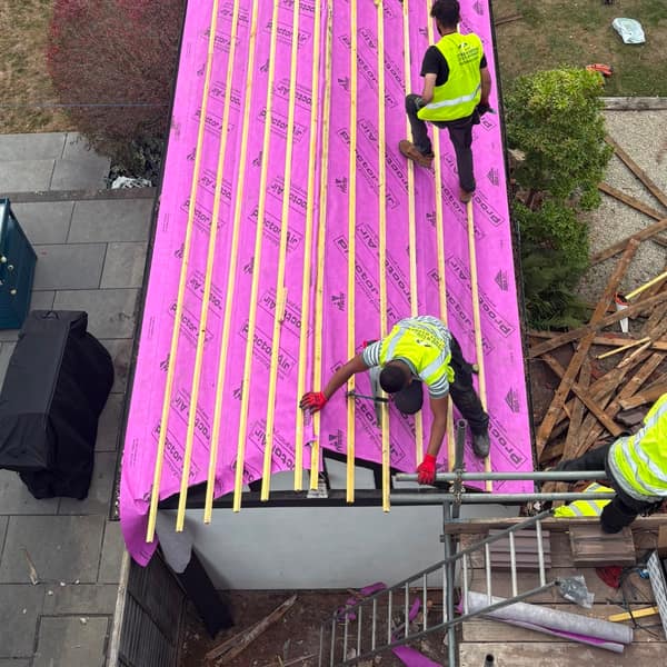 Fixing new battens over the membrane on the garden building roof, Watford